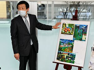 青森市に寄付した絵画について説明する町田光司さん