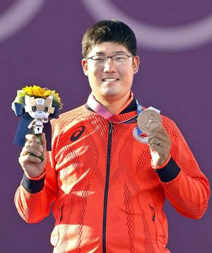 アーチェリー男子個人で獲得した銅メダルを手に笑顔の古川高晴。2012年ロンドン五輪個人「銀」、今大会の男子団体「銅」に続き、自身3個目のメダルとなった＝夢の島公園アーチェリー場（共同）