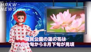 動画内でキャスターに扮して猿賀公園のハスの花をPRする平カワ子